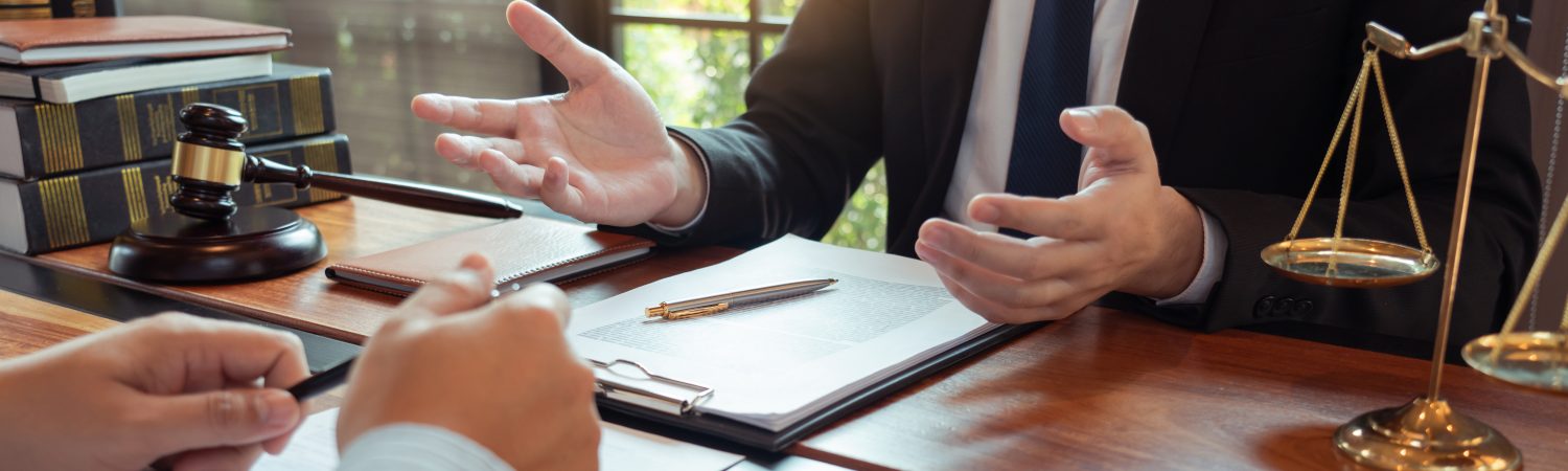 Lawyer,Working,With,Client,Discussing,Contract,Papers,With,Brass,Scale